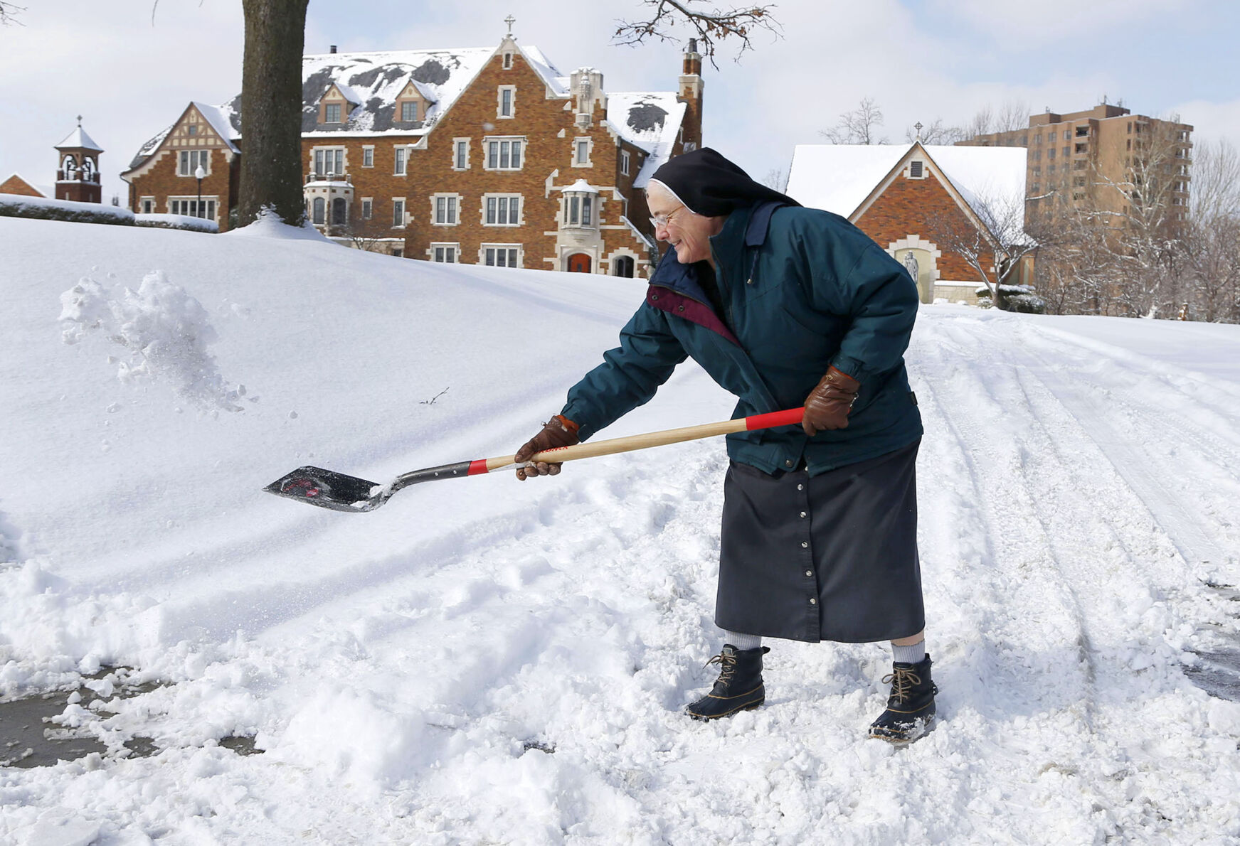 Sister shovels snow